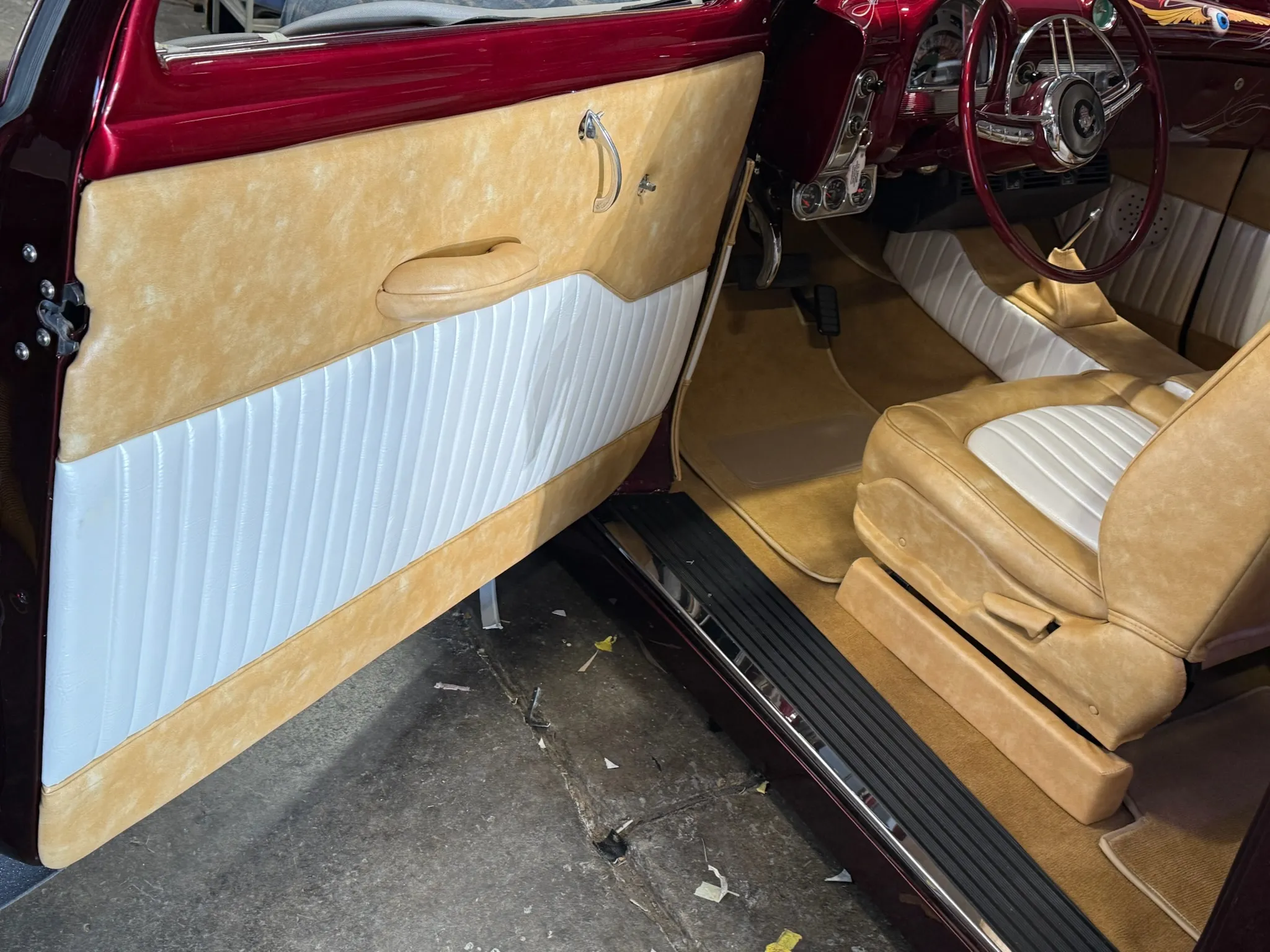 Driver door panel and seat in two‑tone Buick Eight interior.