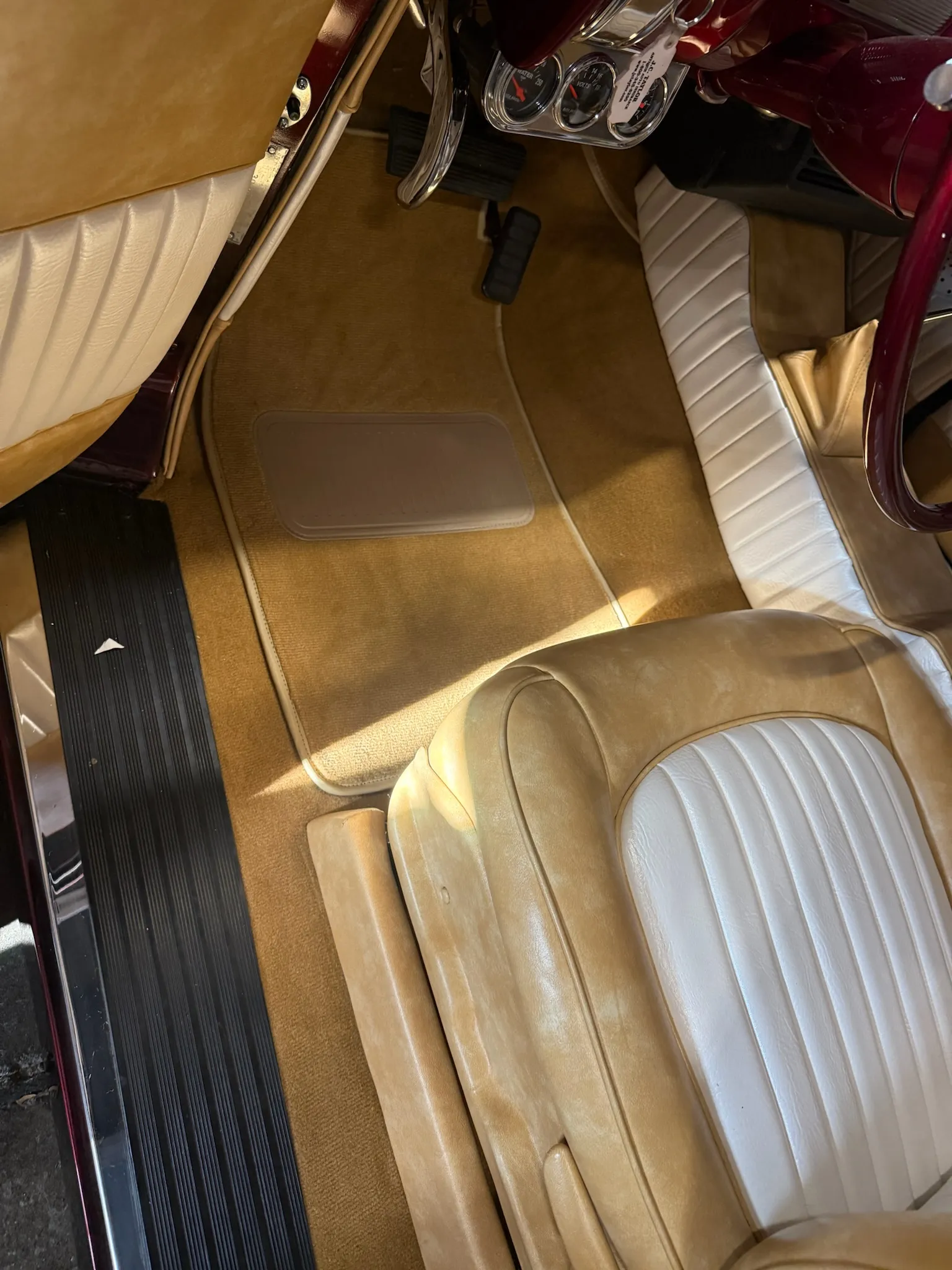 Driver footwell and seat upholstery in the Buick Eight interior.