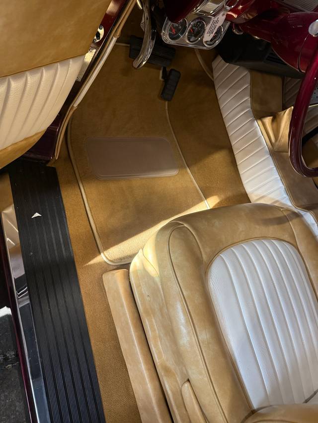 Driver footwell and seat upholstery in the Buick Eight interior.