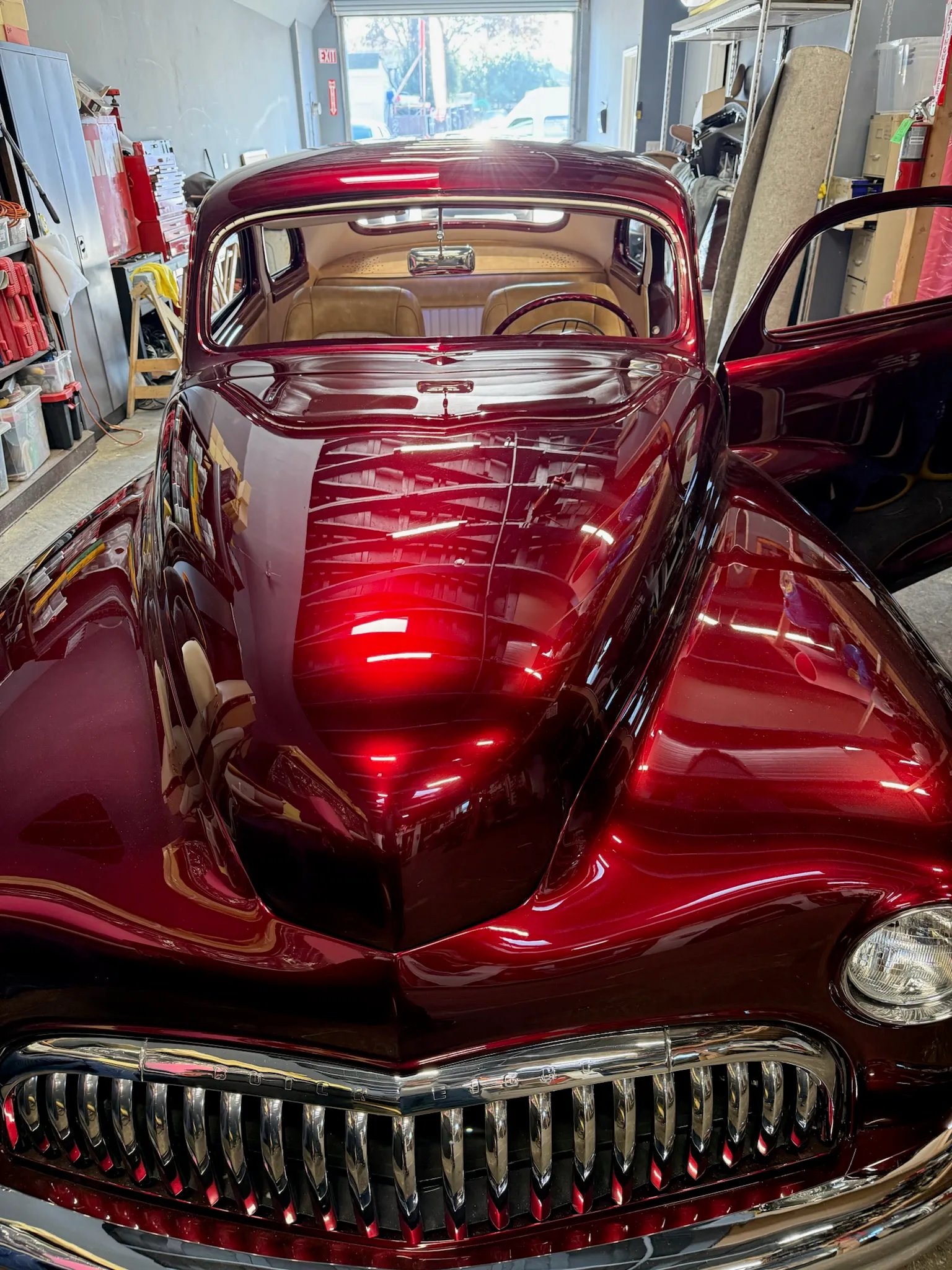 Front view of restored Buick Eight with deep red paint and chrome grille.