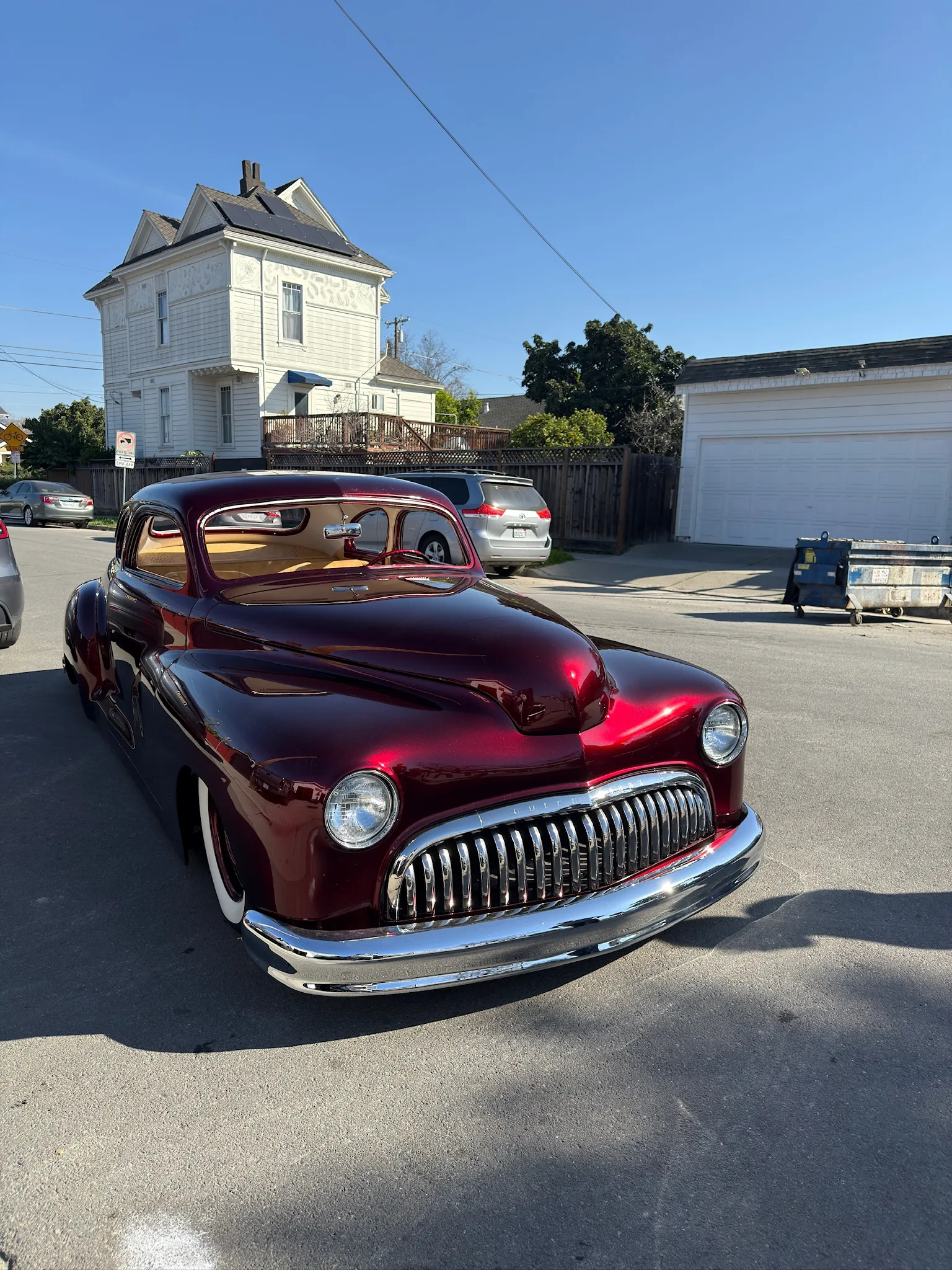 Classic Buick Eight parked outside after custom interior restoration.