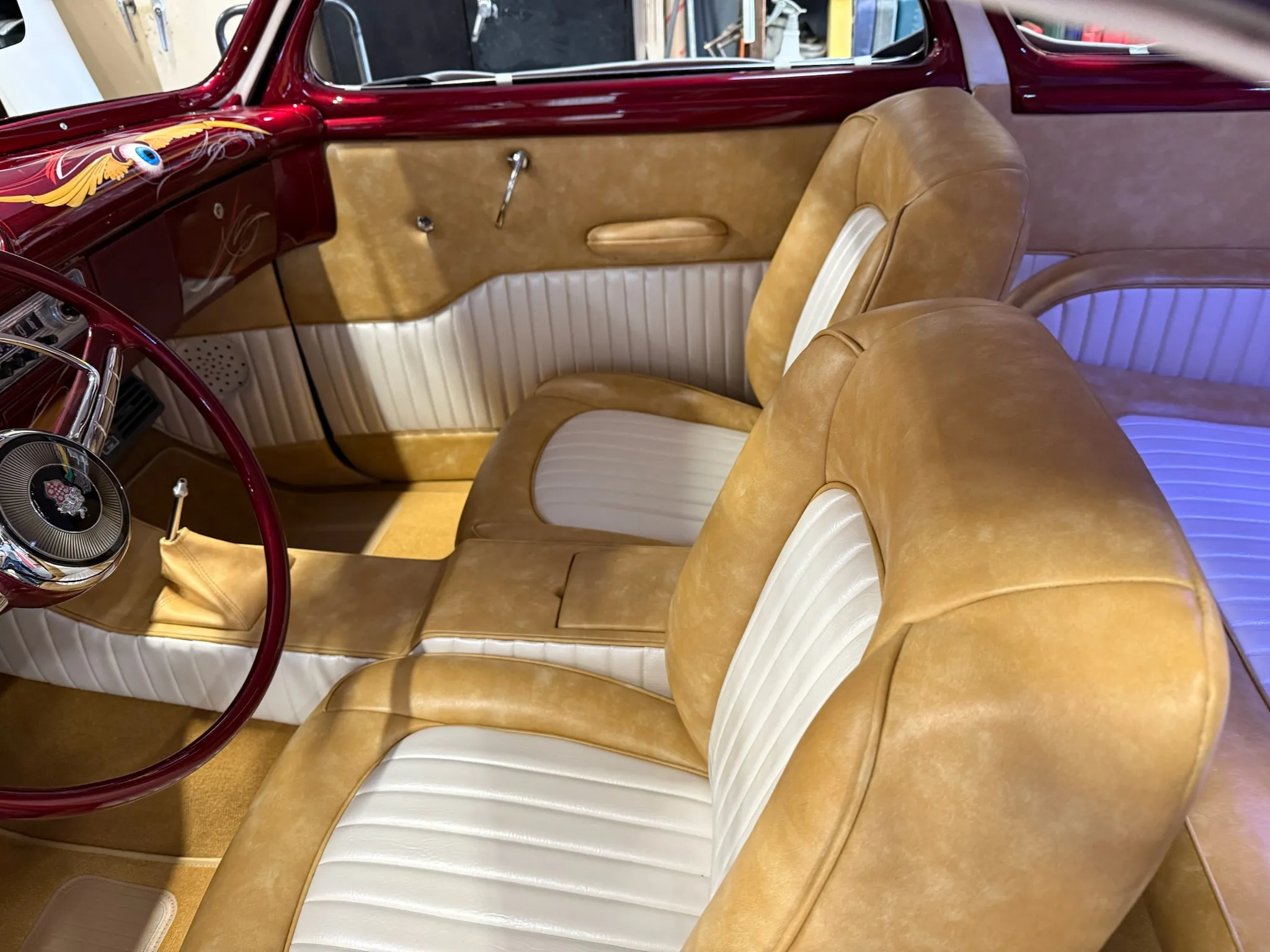Buick Eight front seats with tan bolsters and white inserts.