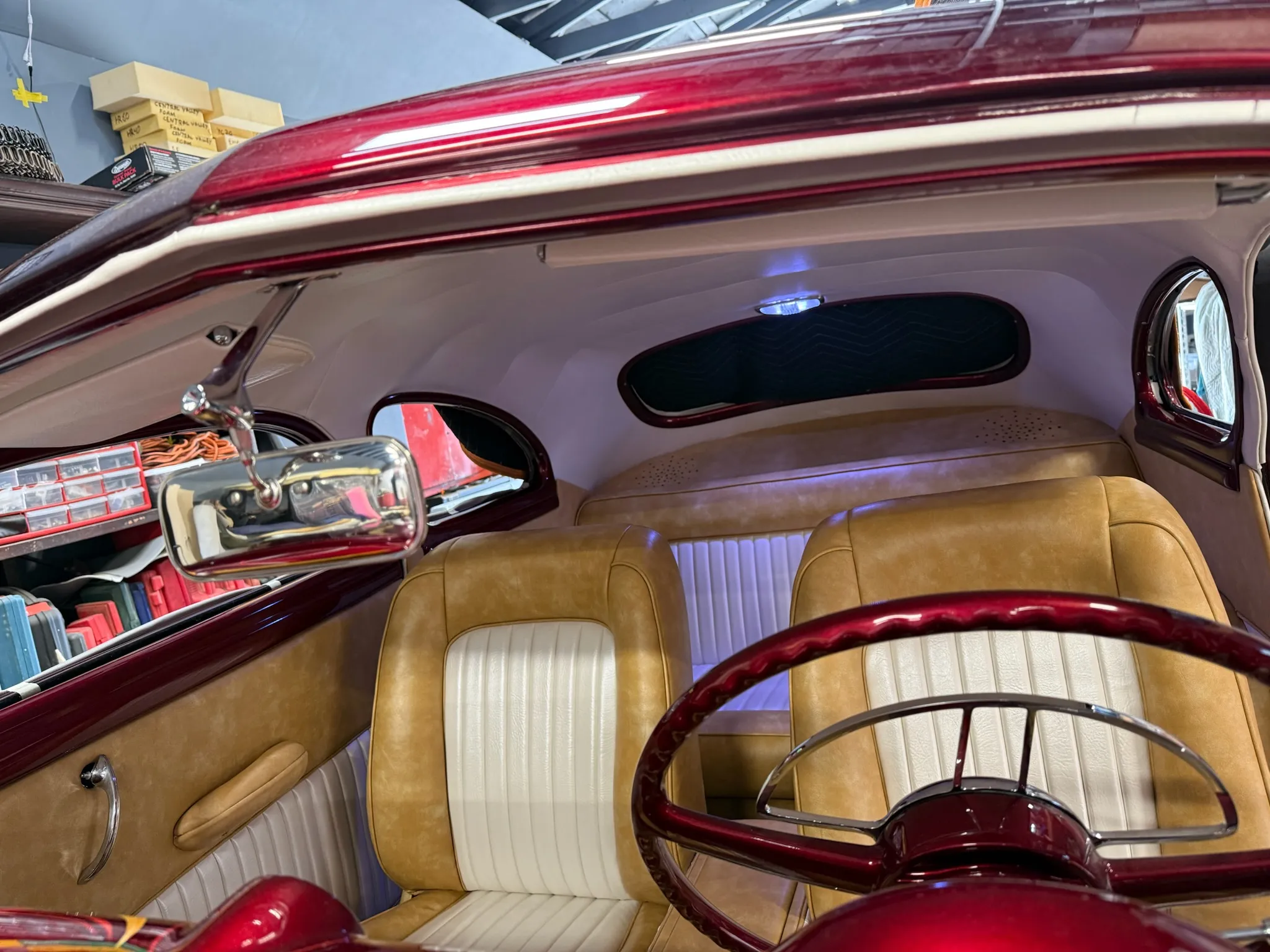 Rear interior view with front seats and finished headliner in Buick Eight.