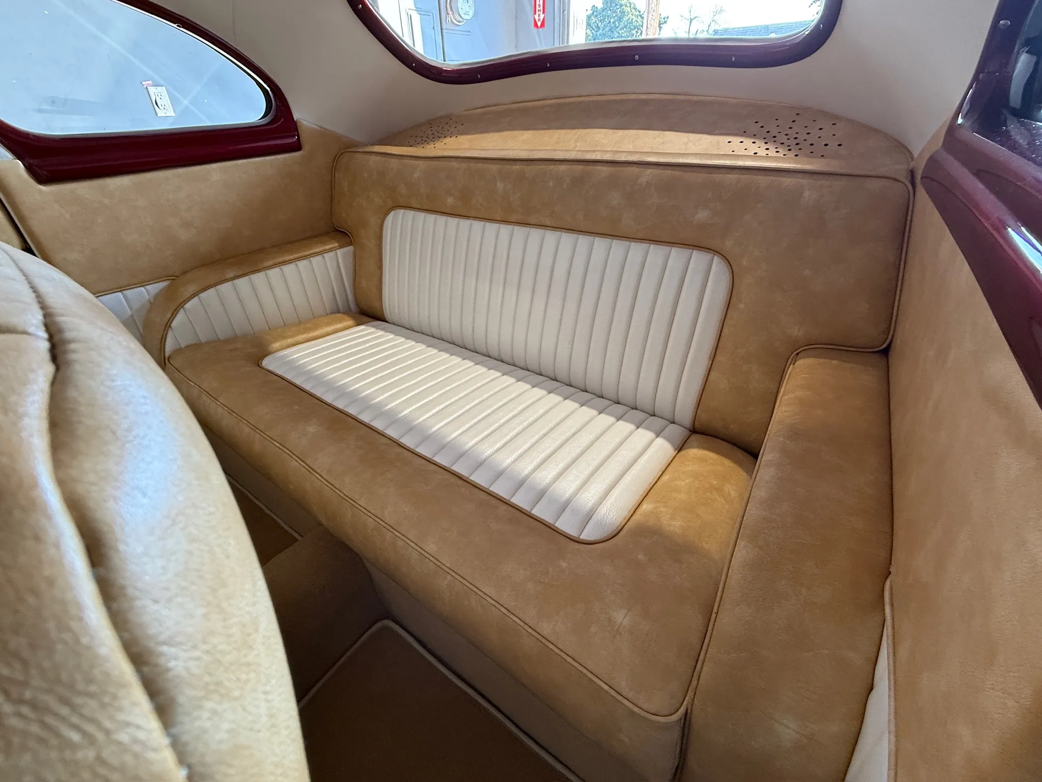Buick Eight rear bench seat in tan and white two‑tone upholstery.