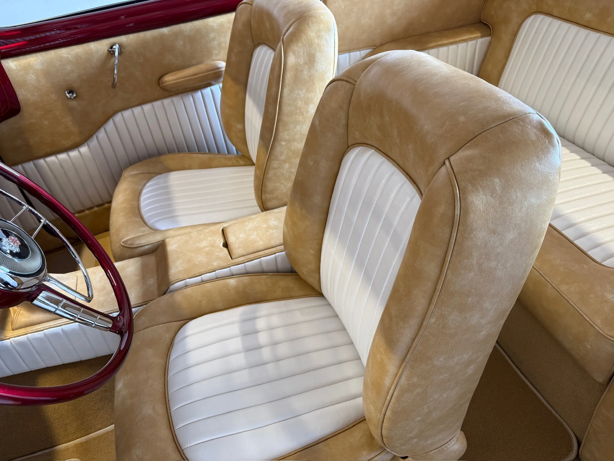 Close‑up of Buick Eight front seats with white pleated inserts.