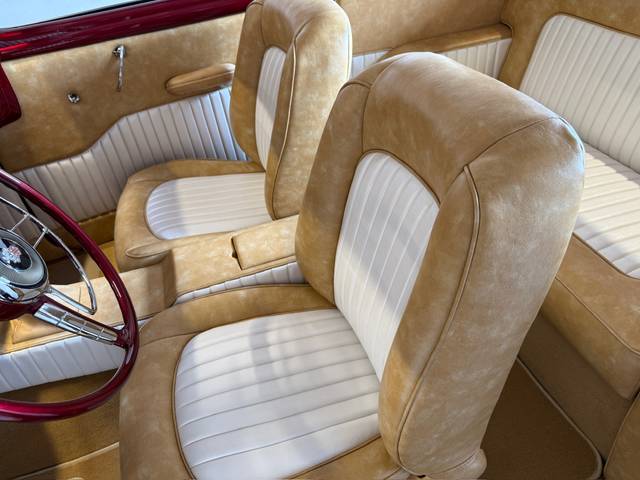 Close‑up of Buick Eight front seats with white pleated inserts.