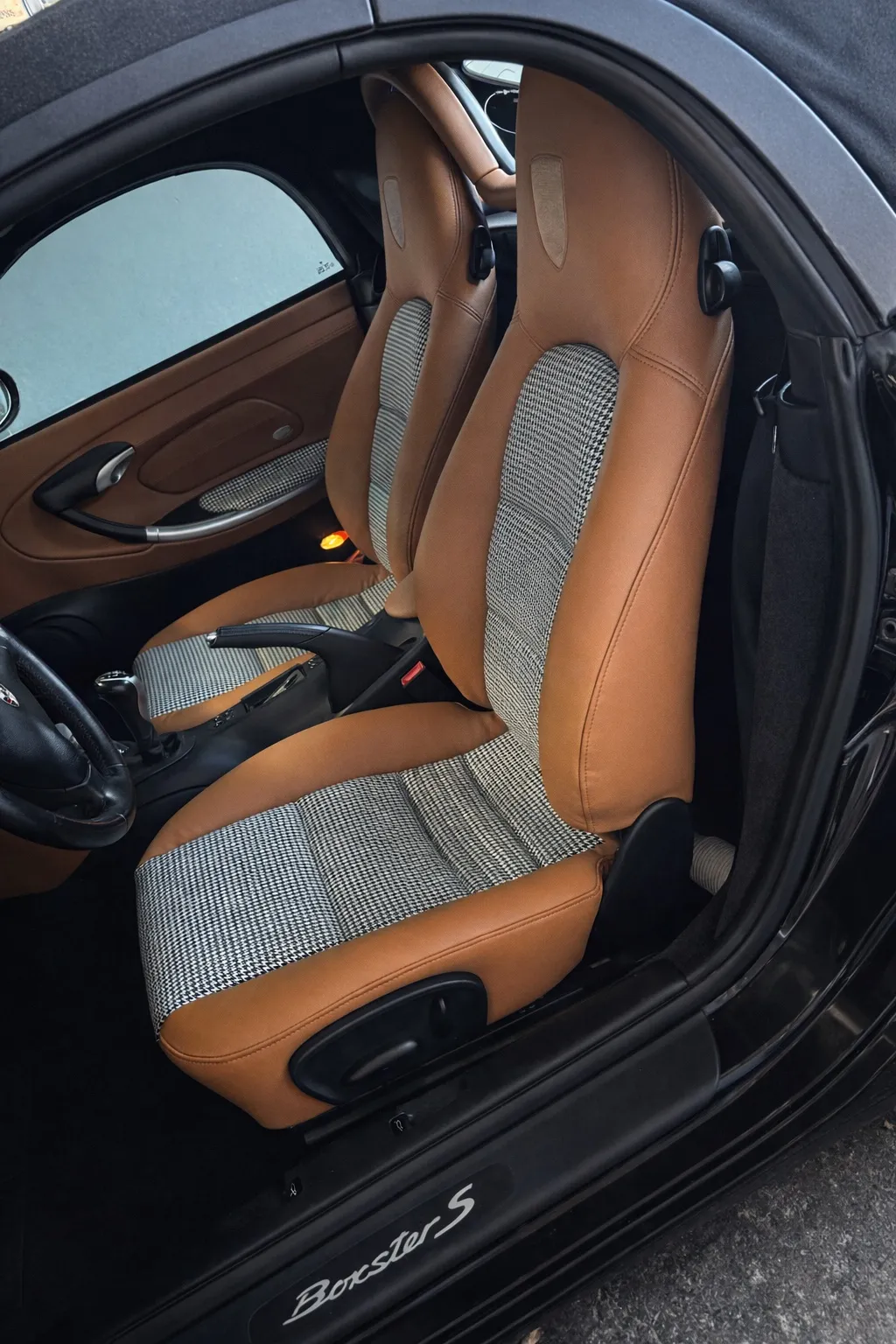 Driver-side angle view of the reupholstered Porsche Boxster S seats.