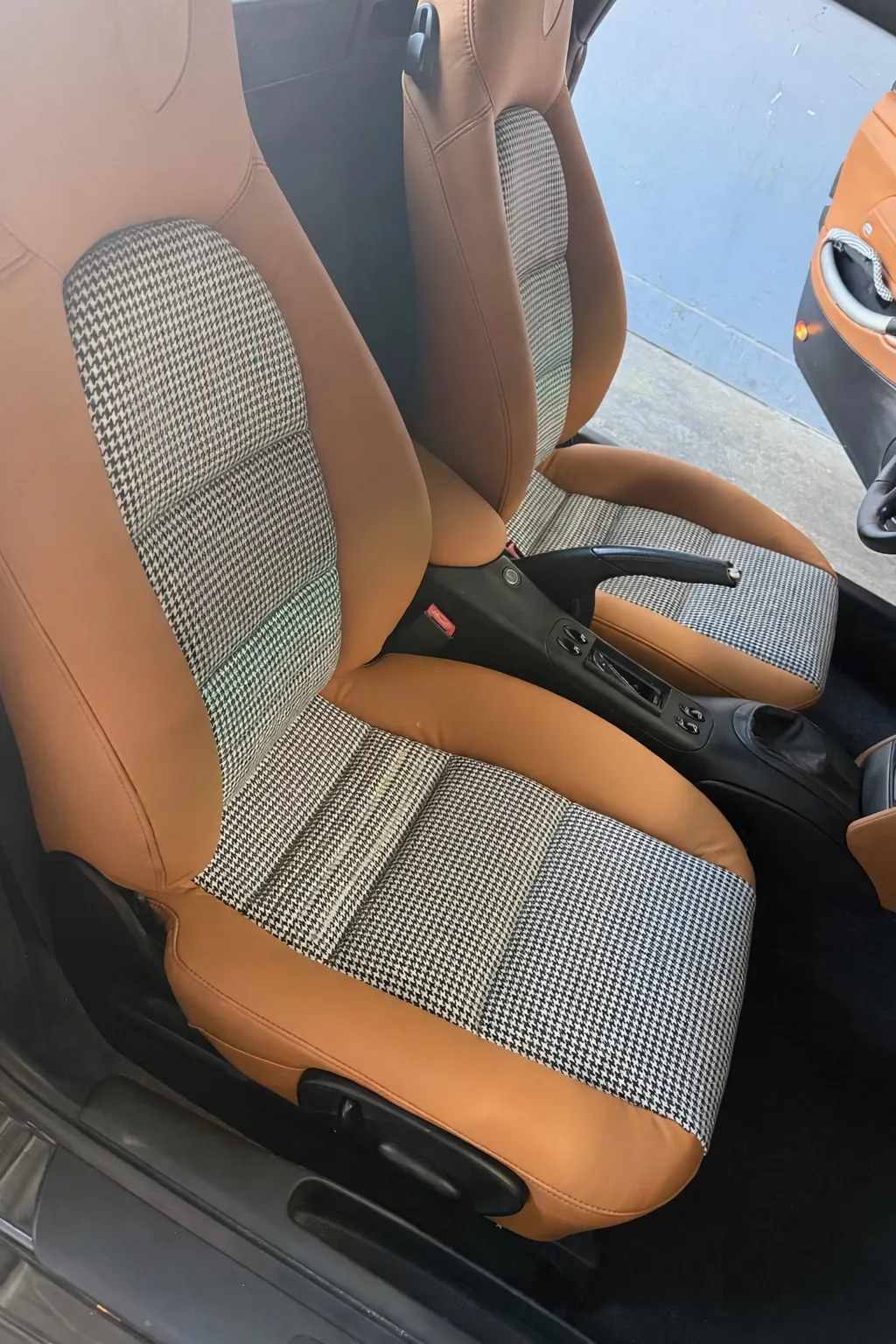 Detail of the Boxster S seat showing houndstooth insert, stitching, and saddle leather.