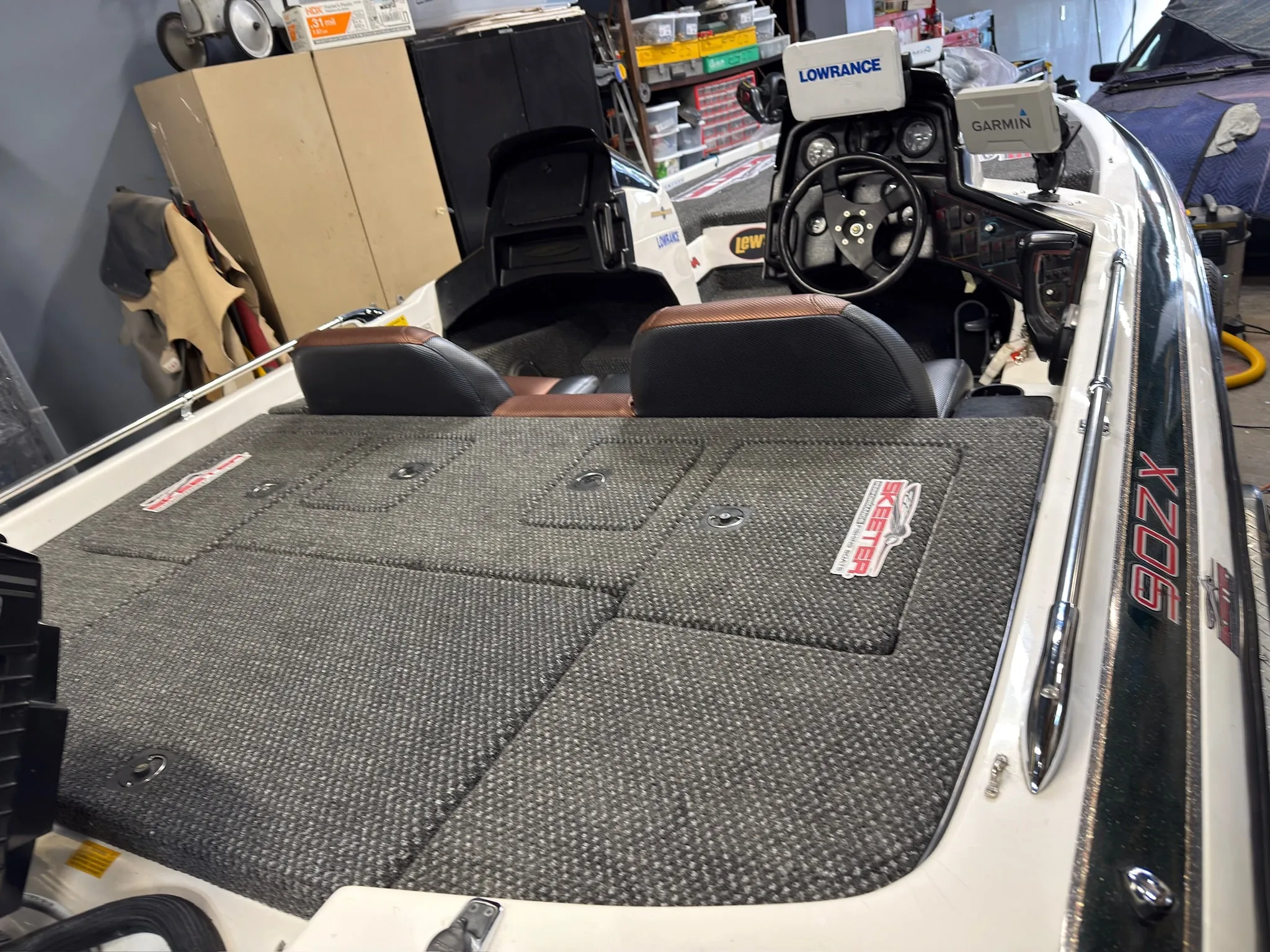 Forward deck view with shop-built reupholstered seats and marine carpet installed.