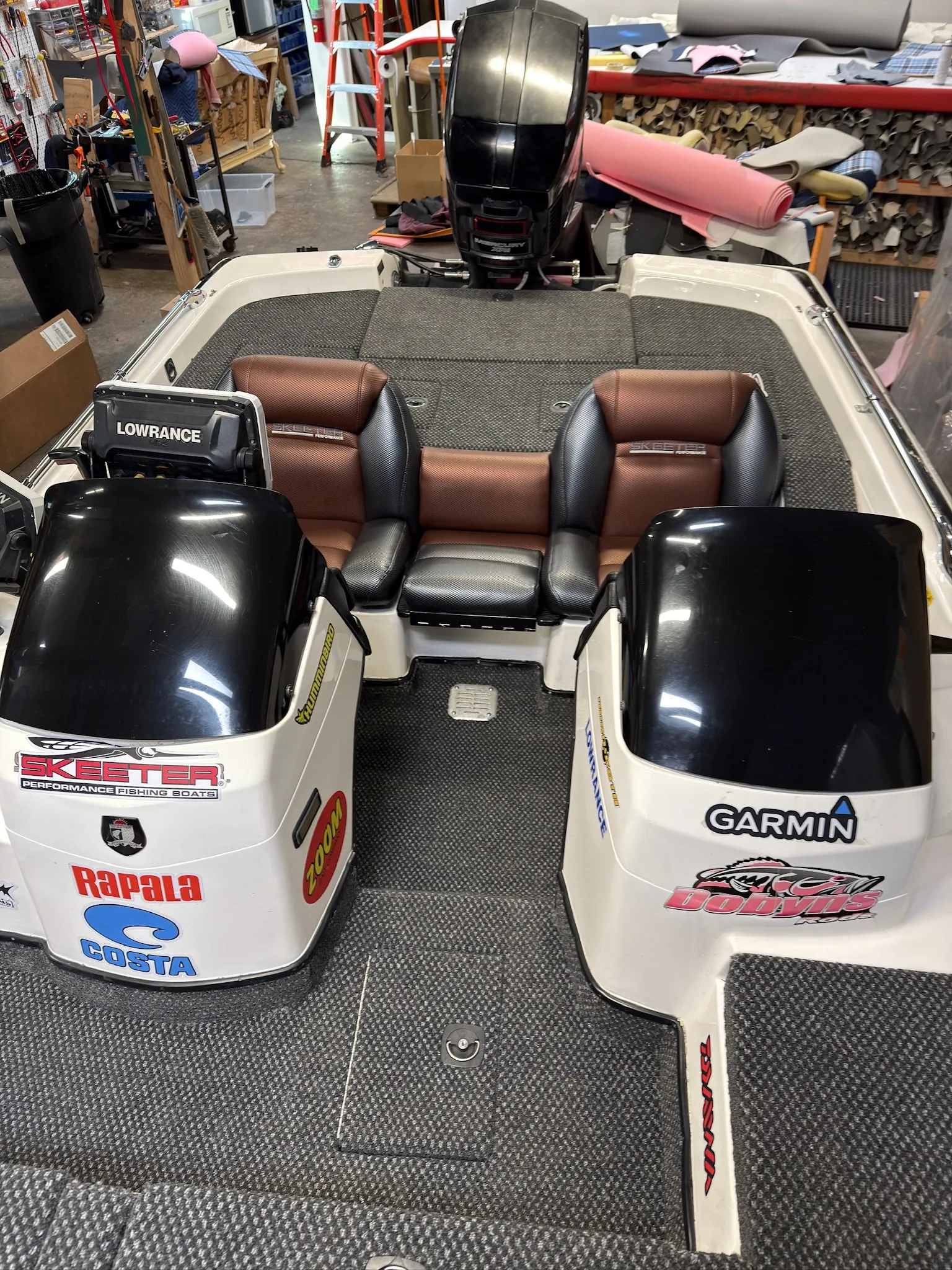 Shop-built black and brown reupholstered seats installed in the Skeeter cockpit.
