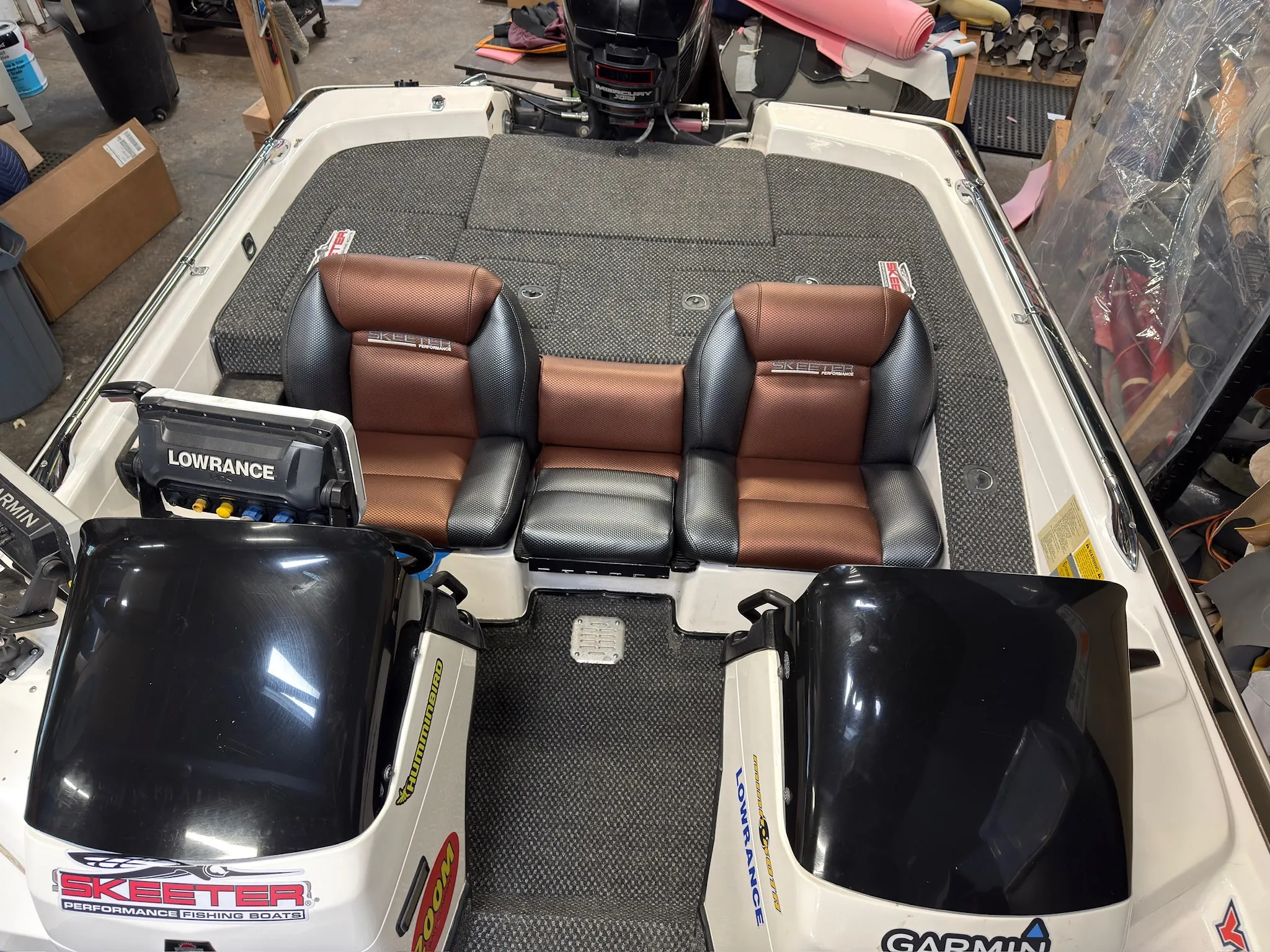 Finished cockpit with shop-built reupholstered seats, shaped foam support, and new marine carpet.