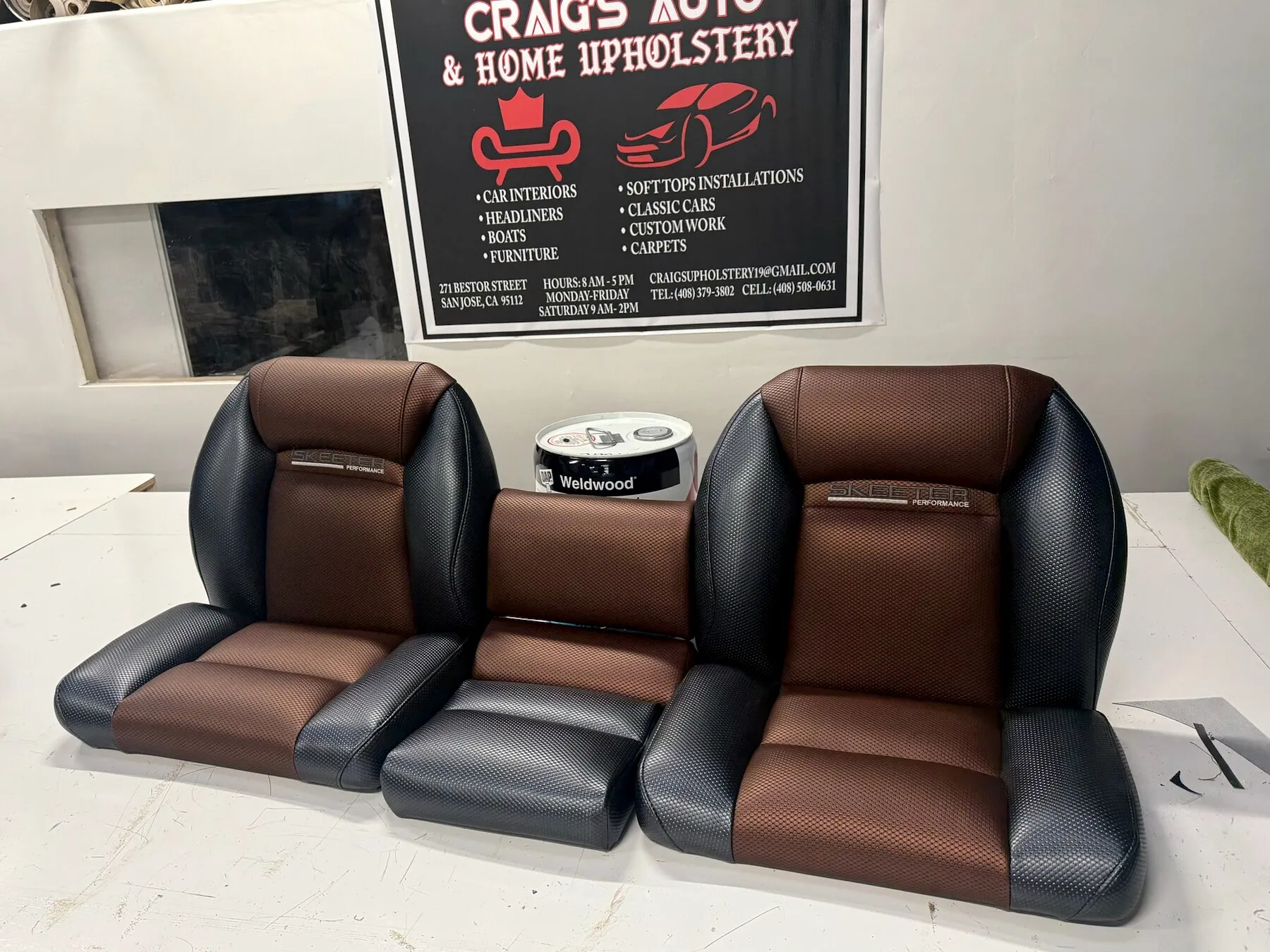 Tan bench seat upholstery work in progress in shop.